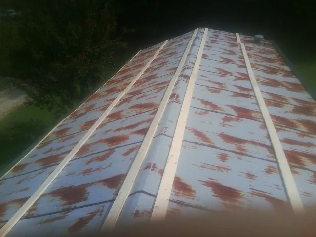 Rusted metal roof panels with new wood purlins before replacement — Storm Damage Roof Repair in Windermere by Roofing Brothers
